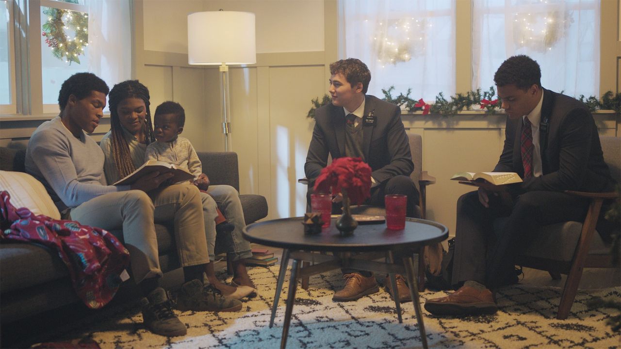 Two elders teach a family inside of their home